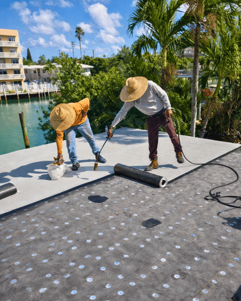 roofing contractors installing flat roof in South Florida